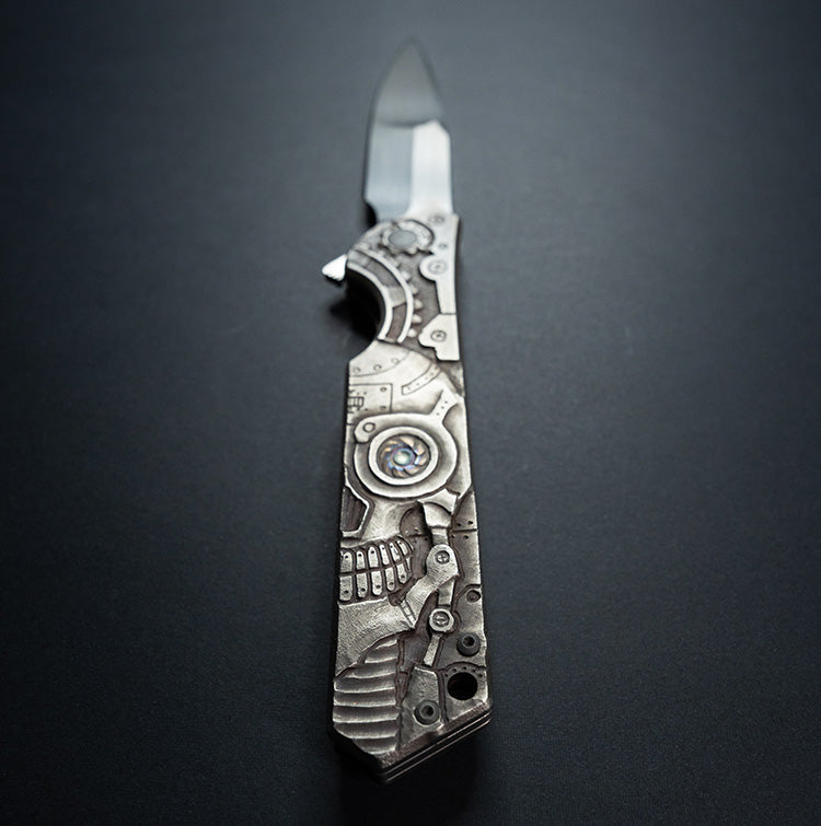 Custom Olamic knife rainmaker on the table