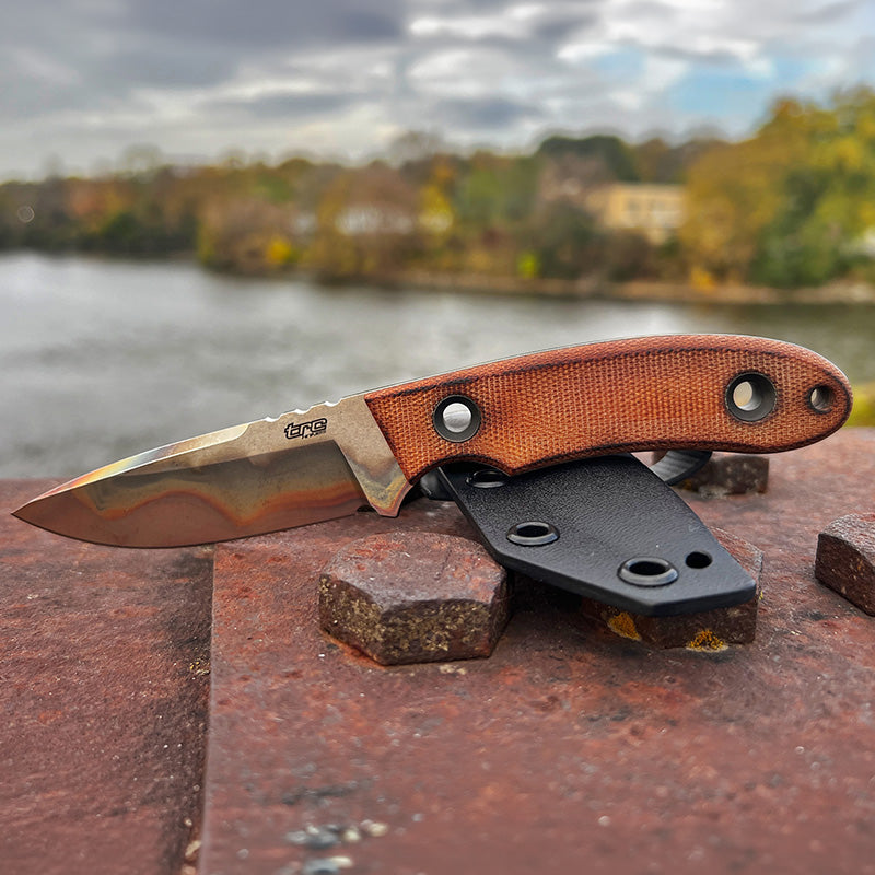 Kosmos Post Apo knife by TRC knives ona bridge