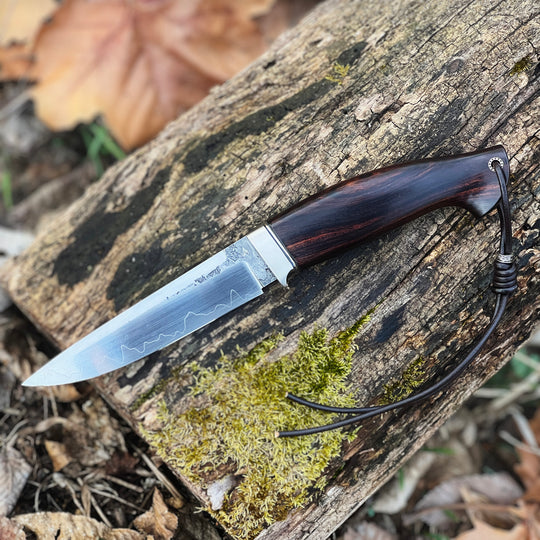 Andrii Titov Model 3 knife on the old wood outside