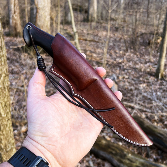 Andrii Titov Model 3 knife in the sheath in the hand outdoor