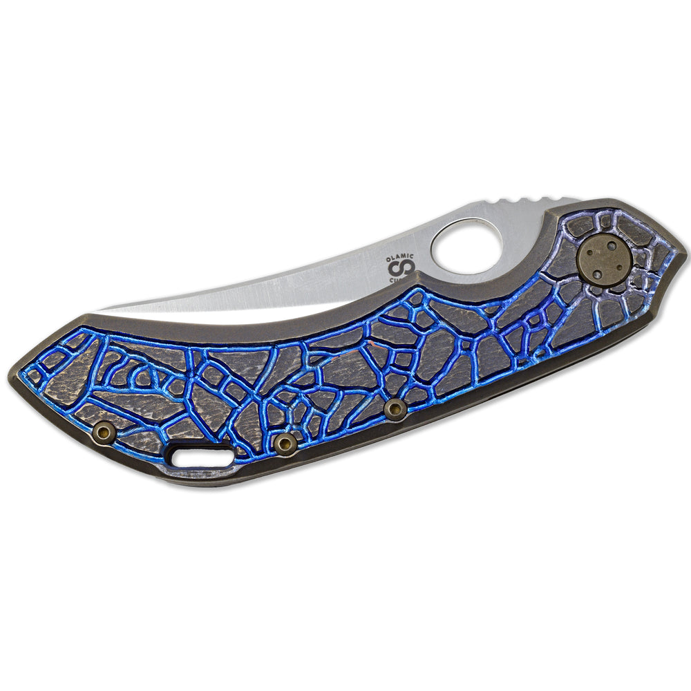 Closed Olamic Wayfarer 247 showing blue anodized titanium handle and Isles carving.