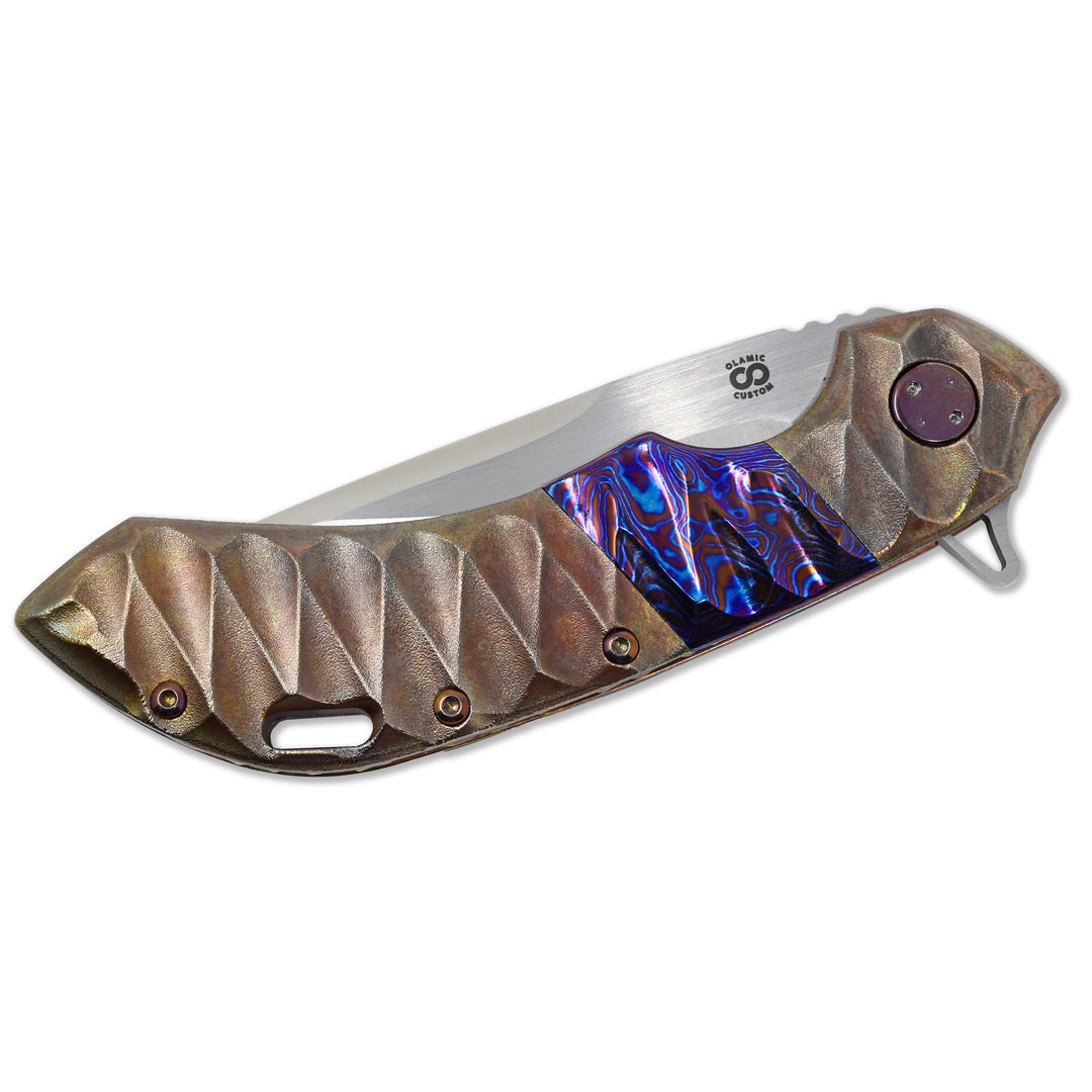 Purple anodized titanium hardware and Timascus inlay on the Olamic Wayfarer 247 frame lock.