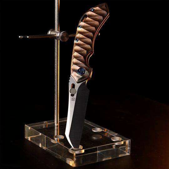 Olamic Wayfarer 247 custom folding knife on a stand
