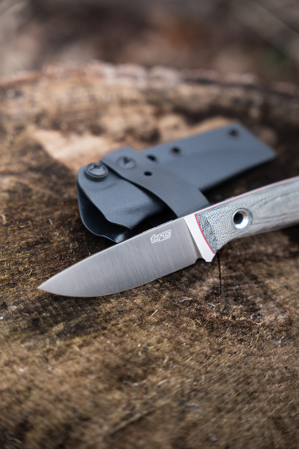 TRC knife Classic Freedom on the wood with kydex sheath near the knife